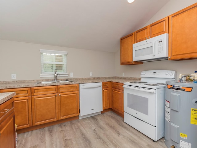 kitchen featuring white appliances, brown cabinets, a sink, light wood-type flooring, and electric water heater
