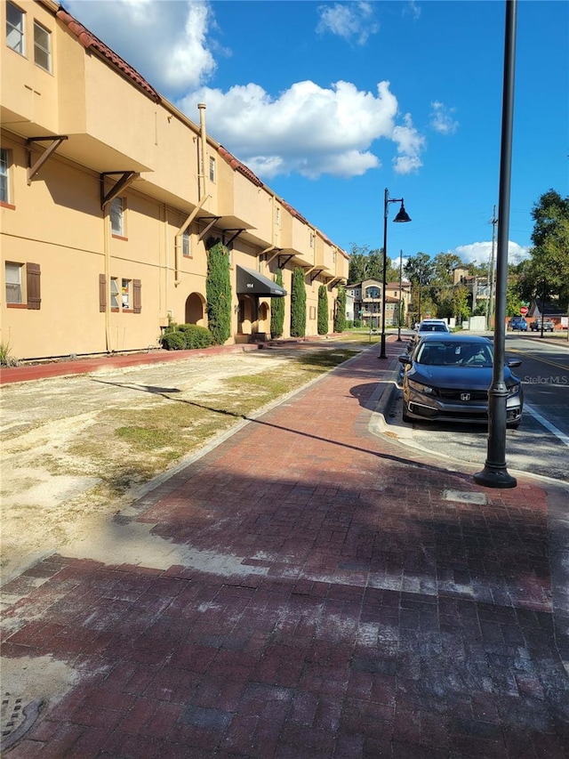 exterior space with sidewalks, street lights, and curbs