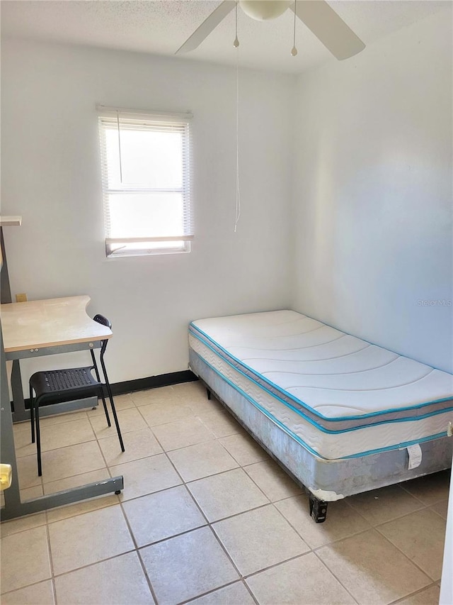 bedroom featuring light tile patterned floors and ceiling fan