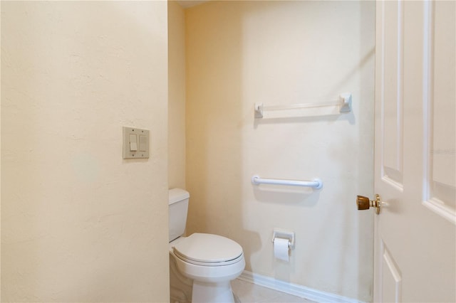 bathroom featuring tile patterned floors and toilet