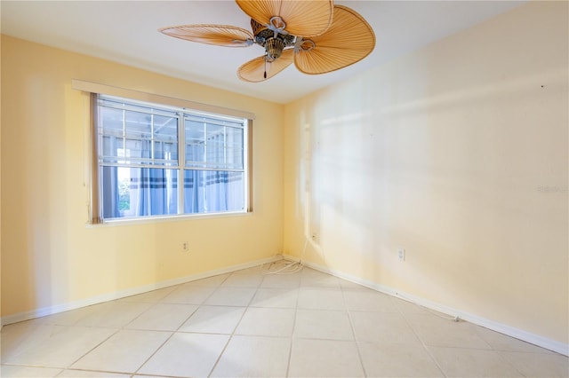 tiled empty room featuring ceiling fan