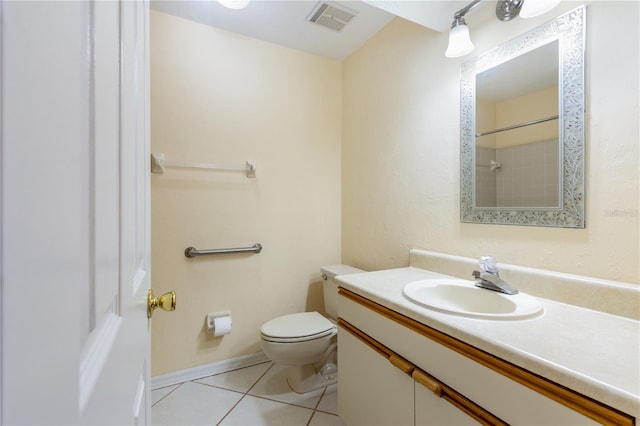 bathroom featuring tile patterned floors, vanity, and toilet