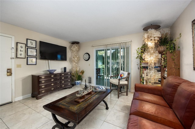 6519 W Newberry Rd Unit 108, Gainesville, FL 32605 - living room featuring light tile patterned floors and baseboards