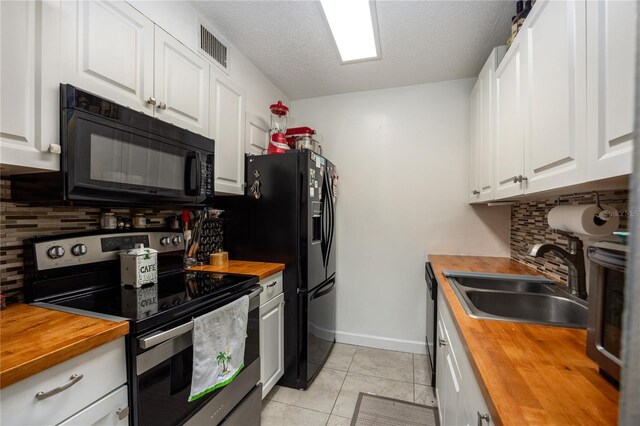 6519 W Newberry Rd Unit 108, Gainesville, FL 32605 - kitchen featuring wooden counters, stainless steel electric range oven, black microwave, a sink, and a textured ceiling