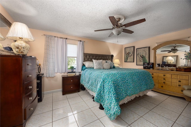 tiled bedroom featuring ceiling fan and a textured ceiling