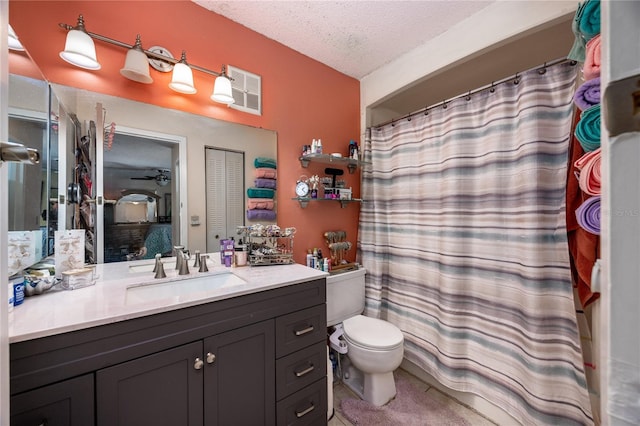 bathroom featuring ceiling fan, a shower with curtain, a textured ceiling, toilet, and vanity