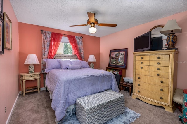 carpeted bedroom featuring a textured ceiling and ceiling fan