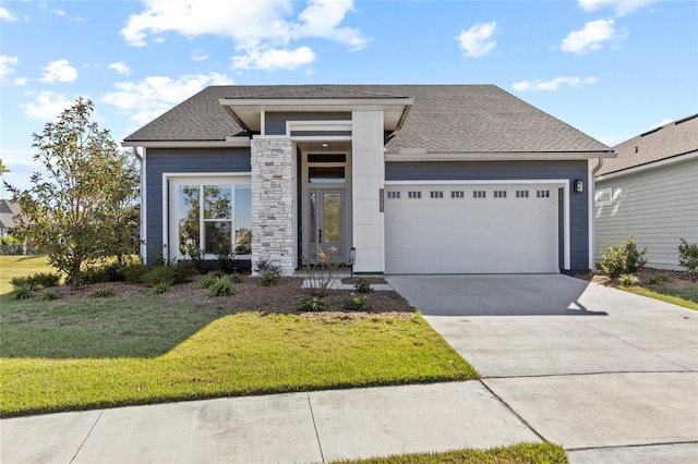 view of front of home with a garage and a front lawn