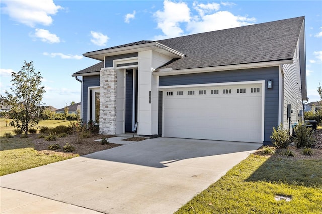 11903 SW 31st Rd, Gainesville, FL 32608 - view of front facade with a shingled roof, concrete driveway, stone siding, and a garage
