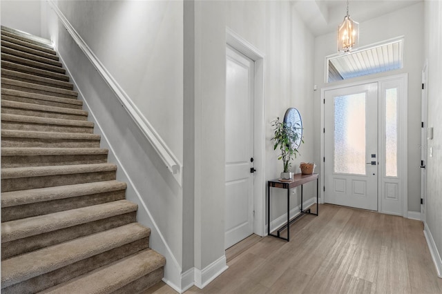 foyer featuring light hardwood / wood-style flooring and a notable chandelier