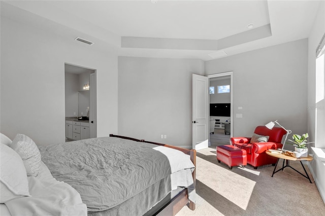 carpeted bedroom featuring connected bathroom