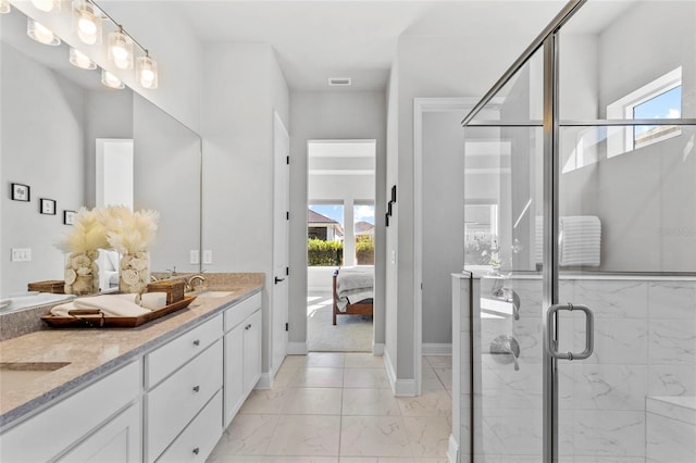 bathroom with plenty of natural light, vanity, and a shower with shower door