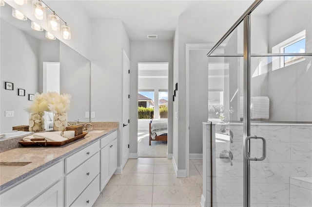 11903 SW 31st Rd, Gainesville, FL 32608 - full bath featuring double vanity, marble finish floors, healthy amount of natural light, and ensuite bath