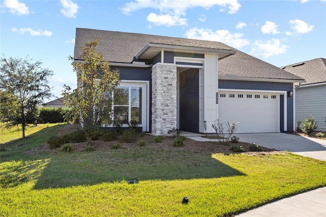 view of front of house with a front yard and a garage