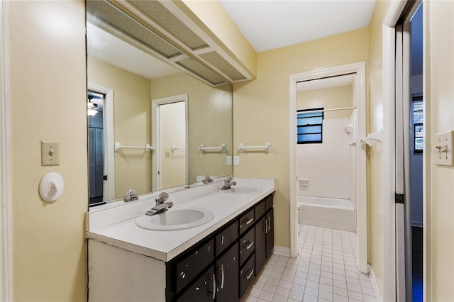 bathroom featuring tile patterned floors, vanity, and tiled shower / bath combo