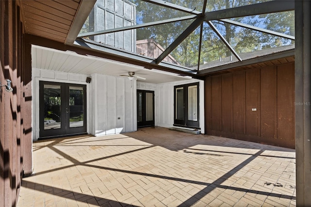 view of patio / terrace featuring glass enclosure, ceiling fan, and french doors