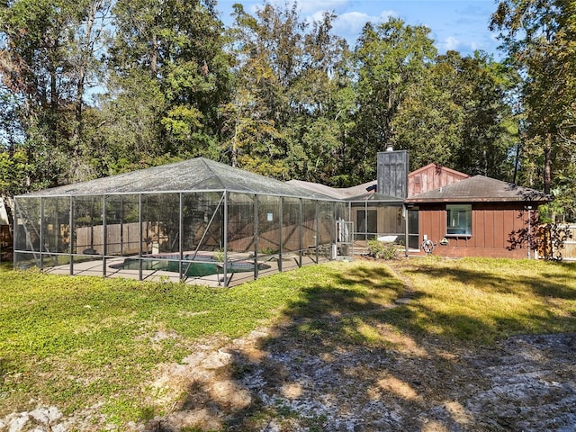 exterior space featuring a yard, a fenced in pool, and a lanai