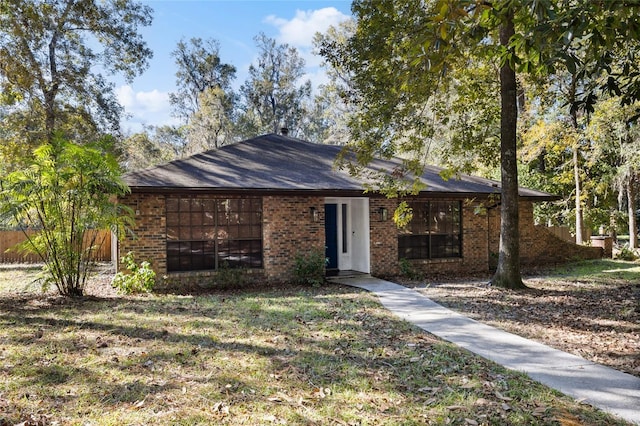 ranch-style home featuring a front yard