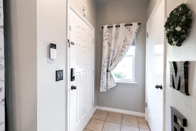 doorway featuring light tile patterned flooring