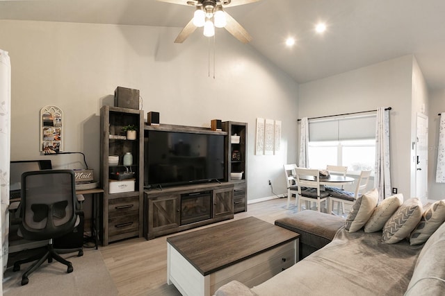 living room with vaulted ceiling, light hardwood / wood-style flooring, and ceiling fan