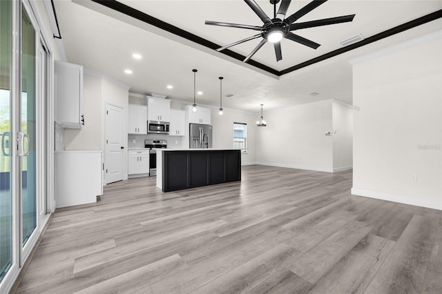 kitchen with stainless steel appliances, a center island with sink, light hardwood / wood-style flooring, white cabinets, and hanging light fixtures