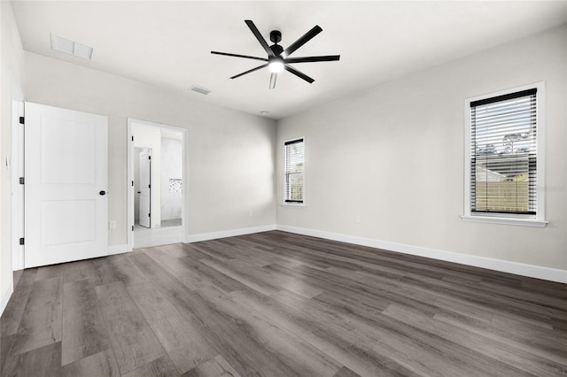 unfurnished room with ceiling fan, plenty of natural light, and dark hardwood / wood-style floors