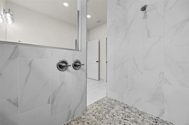 bathroom with tiled shower