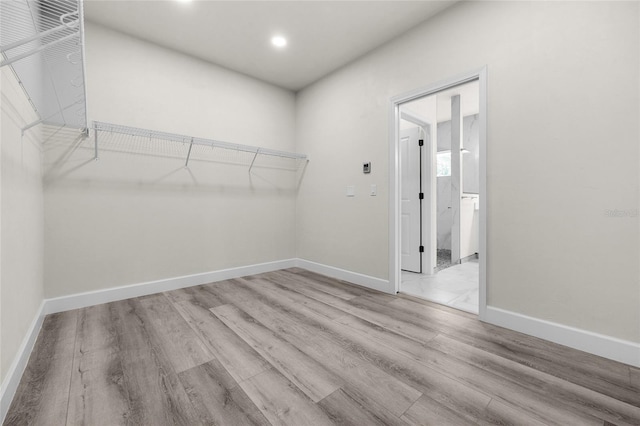 spacious closet featuring light hardwood / wood-style floors