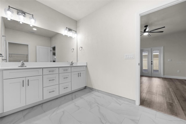 bathroom with hardwood / wood-style floors, ceiling fan, and vanity