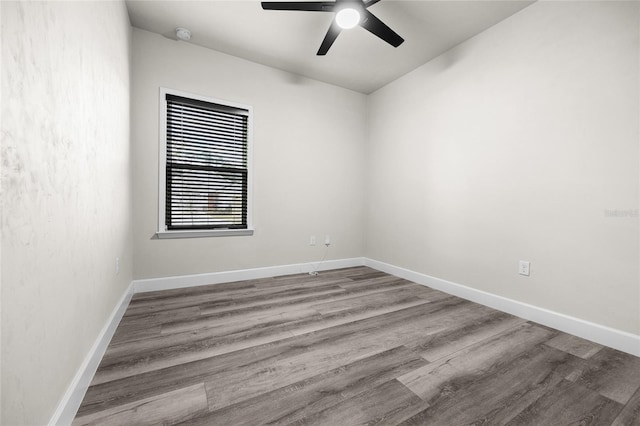 empty room with hardwood / wood-style flooring and ceiling fan