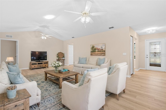 living room featuring ceiling fan, light hardwood / wood-style floors, and vaulted ceiling