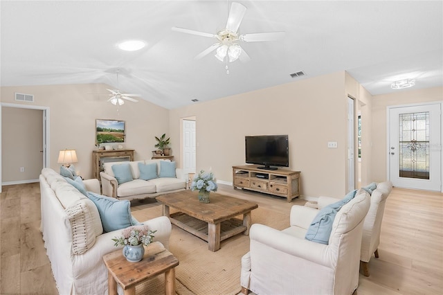 living room featuring light wood-type flooring and lofted ceiling