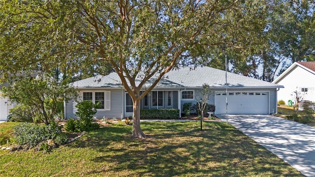 ranch-style house featuring a front yard and a garage