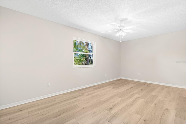 empty room with a textured ceiling, light hardwood / wood-style flooring, and ceiling fan