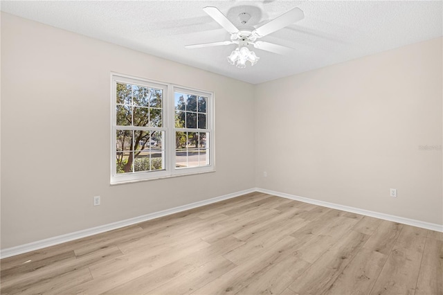 unfurnished room featuring ceiling fan, light wood-type flooring, and a textured ceiling