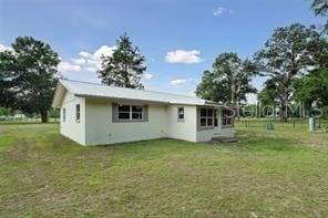 back of house featuring a lawn