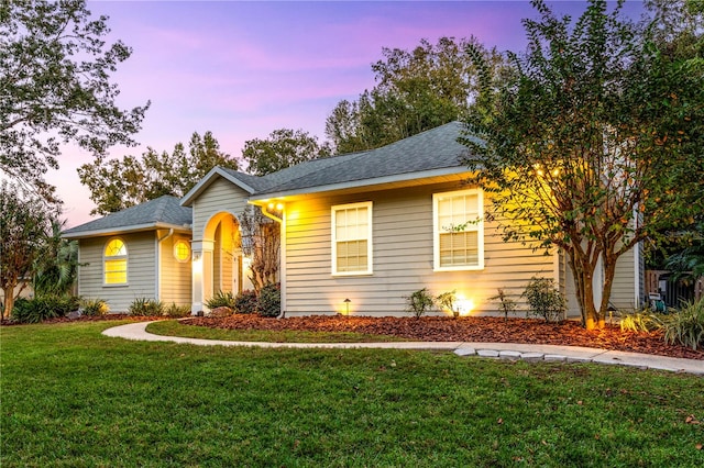 ranch-style house with a lawn