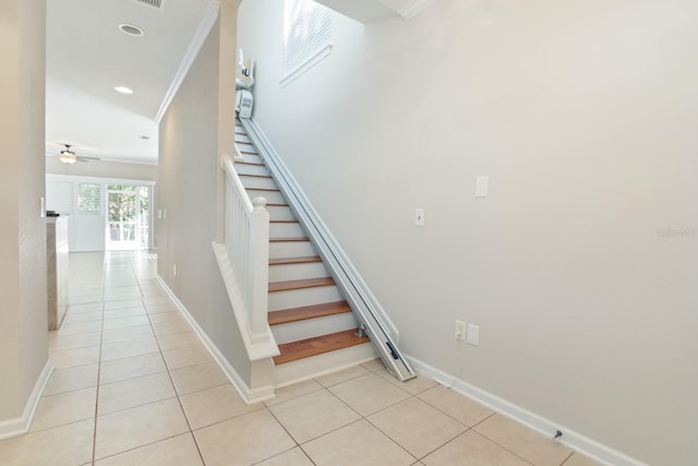 staircase with tile patterned floors, ceiling fan, and ornamental molding