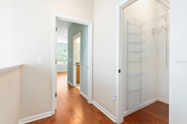 hallway with hardwood / wood-style flooring