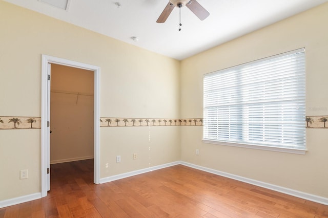 empty room with ceiling fan and hardwood / wood-style floors