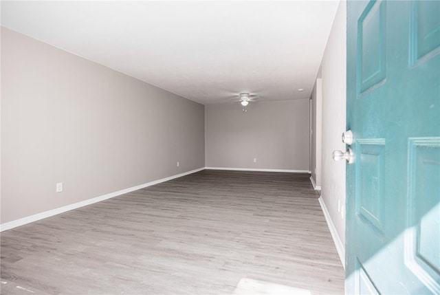 empty room featuring ceiling fan and light wood-type flooring