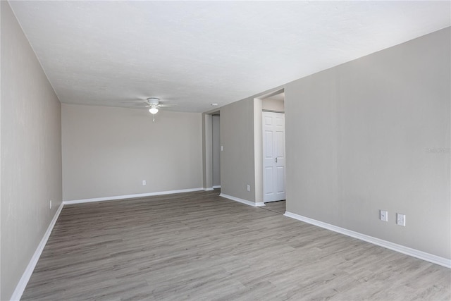 unfurnished room featuring a textured ceiling, light hardwood / wood-style flooring, and ceiling fan