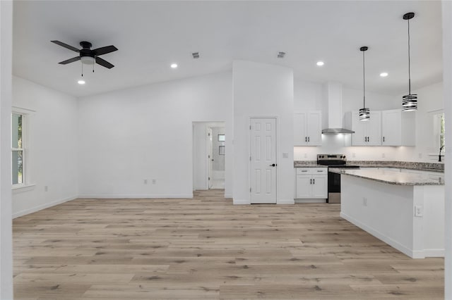 kitchen with light hardwood / wood-style floors, white cabinetry, stainless steel electric stove, and a healthy amount of sunlight