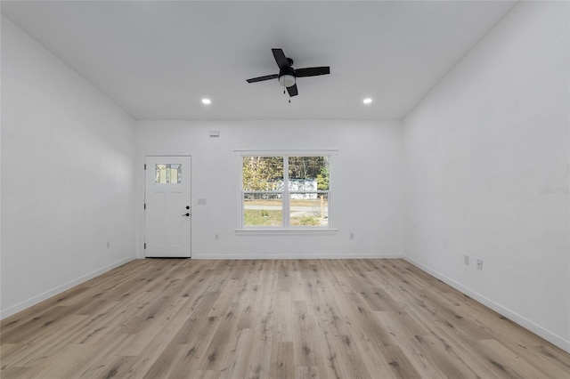 spare room with ceiling fan and light wood-type flooring