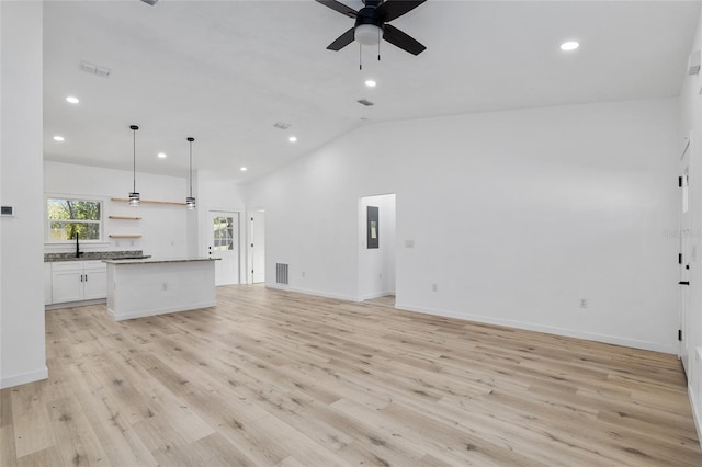 unfurnished living room featuring light hardwood / wood-style flooring, ceiling fan, lofted ceiling, and sink