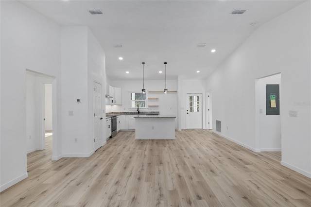 kitchen with a center island, light hardwood / wood-style flooring, white cabinetry, and hanging light fixtures