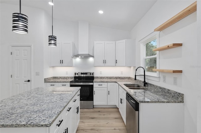 kitchen featuring white cabinets, appliances with stainless steel finishes, lofted ceiling, and pendant lighting