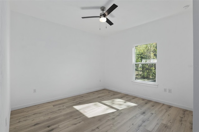 spare room with light hardwood / wood-style flooring and ceiling fan