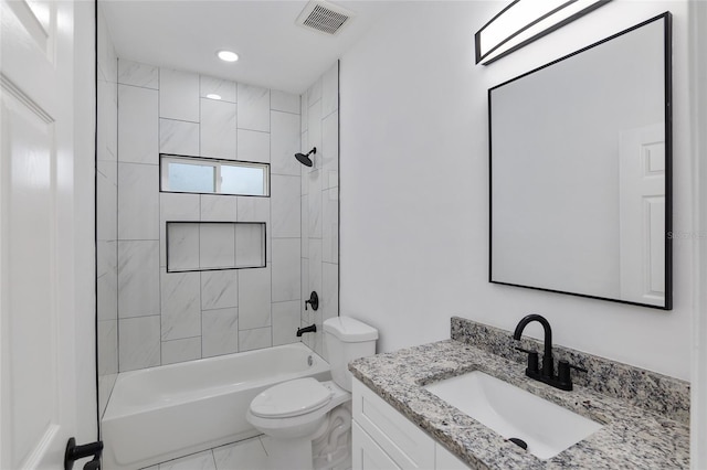 full bathroom with toilet, vanity, and tiled shower / bath