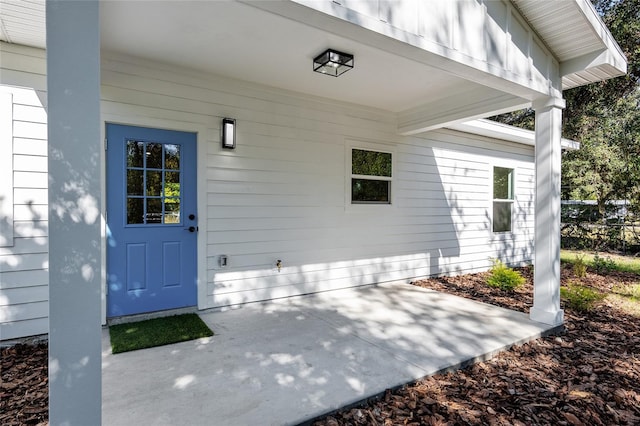 entrance to property featuring a patio